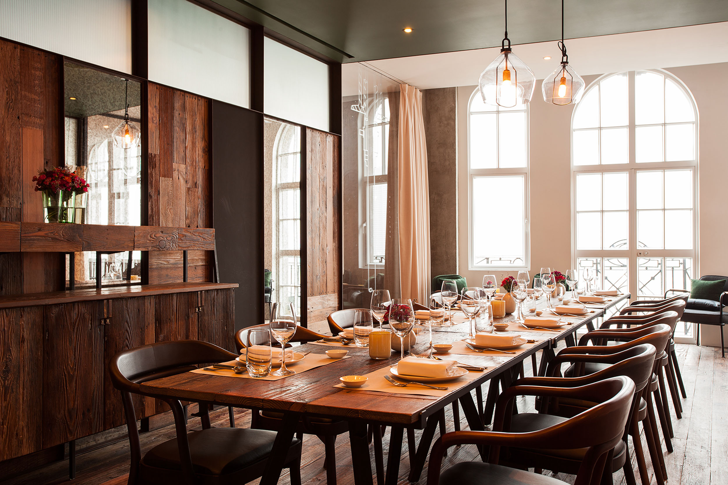 Mercato dining room with reclaimed wood and arched windows